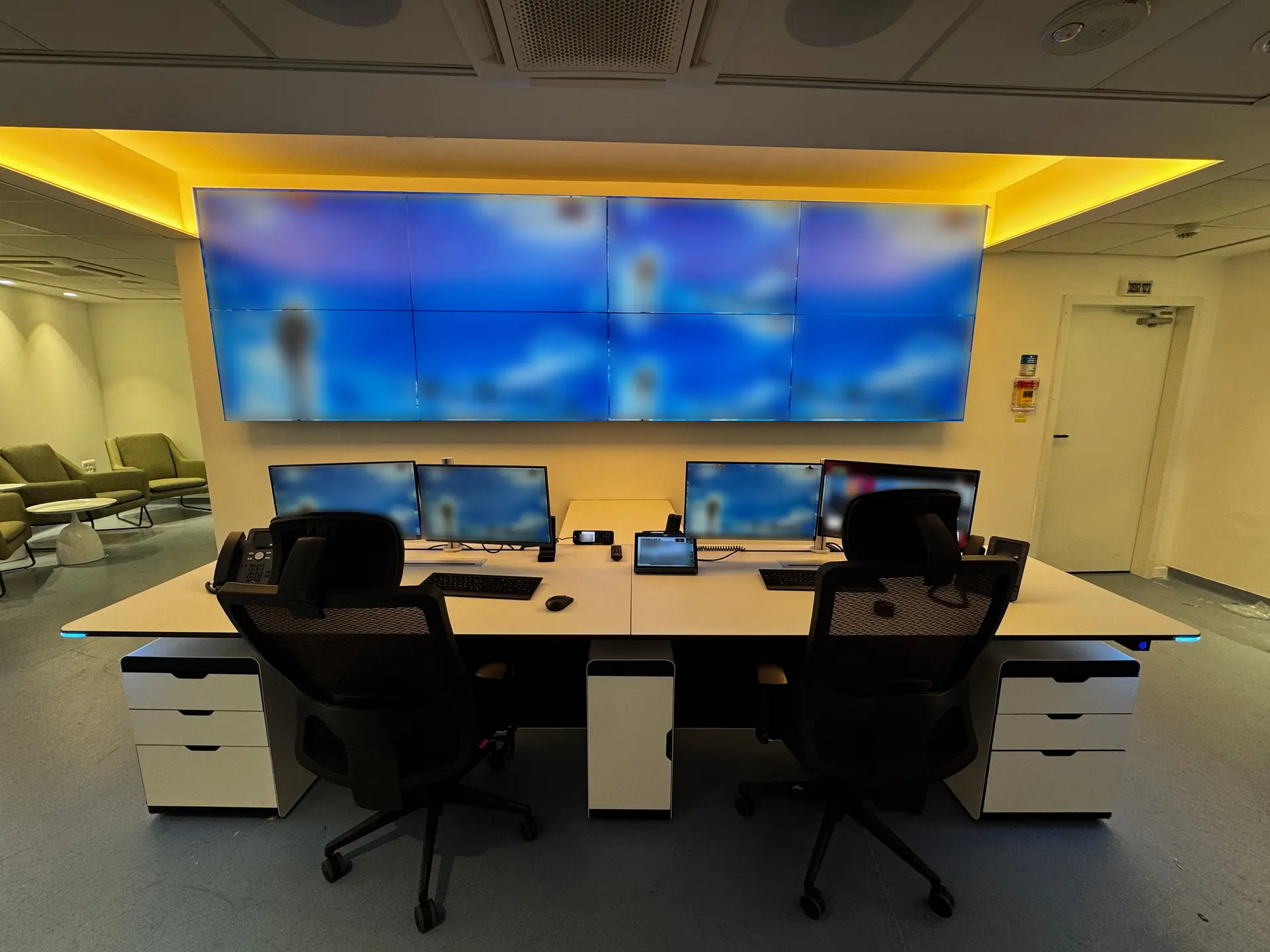 Front view of the Israel Airports Authority operations room, showing workstations and the video wall