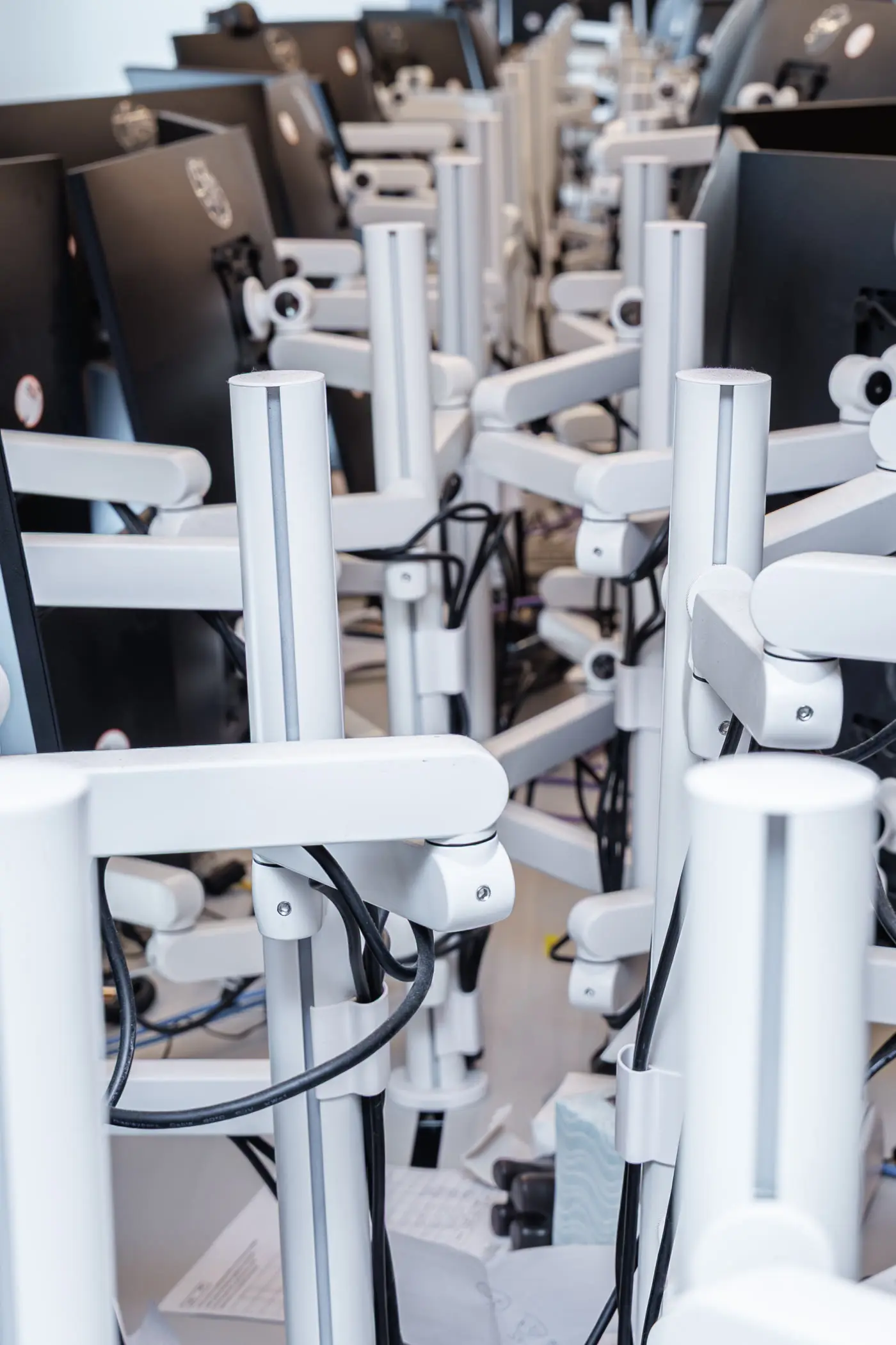 Close view of the monitor-support system across the trading workstations